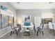 Bright living room featuring a white sofa, glass coffee table, and stylish accent chairs at 835 E Virgo Pl, Chandler, AZ 85249