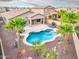 Stunning backyard features a sparkling pool, landscaped yard and covered patio, perfect for entertaining at 835 E Virgo Pl, Chandler, AZ 85249
