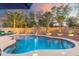 Inviting backyard pool area with palm trees, ambient lighting, and comfortable lounge seating at 835 E Virgo Pl, Chandler, AZ 85249