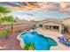 Backyard features a sparkling pool, landscaped yard, patio, and lounge chairs for relaxing outdoor enjoyment at 835 E Virgo Pl, Chandler, AZ 85249