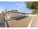 Charming backyard with gravel landscaping, privacy fence, and access to the inviting pool at 8419 N 51St Dr, Glendale, AZ 85302