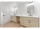 Bathroom with double sink vanity, modern fixtures, and a door to backyard at 8419 N 51St Dr, Glendale, AZ 85302