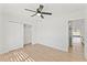 This bedroom offers wood-look flooring, a ceiling fan, and a closet for storage at 8419 N 51St Dr, Glendale, AZ 85302
