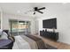 Bedroom featuring a ceiling fan, wood floors, and access to the pool at 8419 N 51St Dr, Glendale, AZ 85302