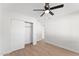 Bedroom with wood-look flooring, ceiling fan, and closet at 8419 N 51St Dr, Glendale, AZ 85302