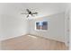 A bright bedroom with wood-look flooring, a ceiling fan, and a backyard view at 8419 N 51St Dr, Glendale, AZ 85302
