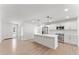 Bright and airy kitchen featuring a center island with seating, wood-look flooring, and ample counter space at 8419 N 51St Dr, Glendale, AZ 85302