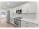 Modern kitchen featuring stainless steel appliances, white cabinets, and quartz countertops, creating a clean aesthetic at 8419 N 51St Dr, Glendale, AZ 85302