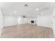 Bright living room featuring wood floors and a painted brick fireplace for cozy relaxation at 8419 N 51St Dr, Glendale, AZ 85302