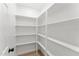 Walk-in pantry with white shelving offering lots of storage for food and kitchen essentials at 8419 N 51St Dr, Glendale, AZ 85302