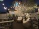 Charming back patio featuring wicker chairs, string lights, and a cozy ambiance perfect for relaxing evenings outdoors at 9144 W Surrey Dr, Peoria, AZ 85381