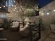 Cozy back patio with comfortable seating and string lights, offering a tranquil and private outdoor living space at 9144 W Surrey Dr, Peoria, AZ 85381