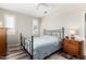 Neutral bedroom with an iron bed frame, soft rug, and bright natural light at 9144 W Surrey Dr, Peoria, AZ 85381