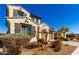View of a two-story home showcasing a stucco exterior, tile roof, shutters and landscaped yard at 9144 W Surrey Dr, Peoria, AZ 85381