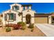 Charming two-story home featuring a stucco exterior, tile roof, shutters and a well-manicured front yard at 9144 W Surrey Dr, Peoria, AZ 85381