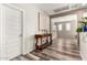 Inviting hallway with wood-look floors, console table, and a view into the adjacent living area at 9144 W Surrey Dr, Peoria, AZ 85381