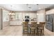 Well-appointed kitchen with stainless steel appliances, granite countertops, tile backsplash, and a breakfast bar at 9144 W Surrey Dr, Peoria, AZ 85381