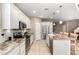 Bright kitchen featuring granite countertops, stainless steel appliances, a breakfast bar and tile backsplash at 9144 W Surrey Dr, Peoria, AZ 85381