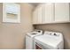 Efficient laundry room with a washer and dryer plus bright natural light at 9144 W Surrey Dr, Peoria, AZ 85381