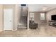 Spacious living room featuring tile floors, a ceiling fan, and a staircase to the second floor at 9144 W Surrey Dr, Peoria, AZ 85381