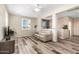 Comfortable living room area with wood-look floors, neutral paint, and natural light at 9144 W Surrey Dr, Peoria, AZ 85381