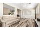 Open-concept living room with neutral paint, wood-look floors, and lots of natural light at 9144 W Surrey Dr, Peoria, AZ 85381