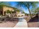 Scenic view of the home and a sidewalk winding through lush landscaping in the neighborhood at 9144 W Surrey Dr, Peoria, AZ 85381