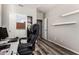 Office with sliding door closet, wood-look floors, and a large black office chair at 9144 W Surrey Dr, Peoria, AZ 85381