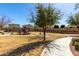 Landscaped playground with a swing set and walking path at 9144 W Surrey Dr, Peoria, AZ 85381
