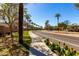 Street with a sidewalk, street trees, and landscaped median showcasing the well-maintained community at 9144 W Surrey Dr, Peoria, AZ 85381