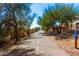 Scenic view of a paved walking trail with a 'New River Trail' sign at 9144 W Surrey Dr, Peoria, AZ 85381