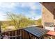 Balcony with a table and chairs overlooking mature landscaping and a community pool at 9716 N 3Rd Dr, Phoenix, AZ 85021