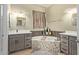 Luxurious bathroom features a soaking tub with decorative tile and dual vanities with grey cabinets at 9716 N 3Rd Dr, Phoenix, AZ 85021