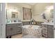 Relaxing bathroom showcasing a tub, dual vanities with gray cabinets and decorative lighting fixtures at 9716 N 3Rd Dr, Phoenix, AZ 85021