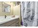 A tidy bathroom features a vanity with a stylish sink and a shower with a decorative shower curtain at 9716 N 3Rd Dr, Phoenix, AZ 85021