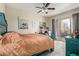 Cozy bedroom with turquoise furniture, a ceiling fan and a sliding glass door with access to the patio at 9716 N 3Rd Dr, Phoenix, AZ 85021