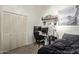 This bedroom is set up as an office, with closet, desk, chair, monitors, and bed at 9716 N 3Rd Dr, Phoenix, AZ 85021