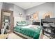 A modern bedroom design highlighted by a tufted headboard, green comforter set, and a large mirror accent at 9716 N 3Rd Dr, Phoenix, AZ 85021