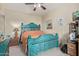 Comfortable bedroom with turquoise bed frame, neutral colored walls, and ceiling fan for ideal climate control at 9716 N 3Rd Dr, Phoenix, AZ 85021