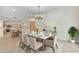 Open-concept dining area features a modern chandelier and seamless transition to the kitchen and other living spaces at 9716 N 3Rd Dr, Phoenix, AZ 85021