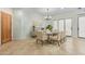 Formal dining room with a white table, seating for eight, modern chandelier, and neutral decor at 9716 N 3Rd Dr, Phoenix, AZ 85021