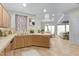 Bright kitchen features light wood cabinets, and an open floor plan extending to the living room and dining area at 9716 N 3Rd Dr, Phoenix, AZ 85021