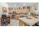 Traditional kitchen design with light wood cabinets, stainless steel appliances, and a breakfast bar area at 9716 N 3Rd Dr, Phoenix, AZ 85021