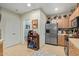 Spacious kitchen layout offering stainless steel appliances, wood cabinets and access to a nearby half bathroom at 9716 N 3Rd Dr, Phoenix, AZ 85021