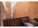 Cozy outdoor patio with a chair and a partial view framed by stucco walls and metal fencing at 9716 N 3Rd Dr, Phoenix, AZ 85021
