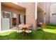 Outdoor patio features a round table with four chairs and an artificial lawn with bright colorful accents at 9716 N 3Rd Dr, Phoenix, AZ 85021