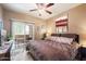 Comfortable bedroom with a ceiling fan, and balcony access at 10030 W Indian School Rd # 203, Phoenix, AZ 85037