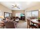 Inviting living room with a ceiling fan, plush sofa, and access to a balcony at 10030 W Indian School Rd # 203, Phoenix, AZ 85037