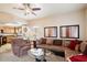 Spacious living room with kitchen featuring wood cabinets and open to kitchen at 10030 W Indian School Rd # 203, Phoenix, AZ 85037