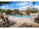 Community pool with lounge chairs, perfect for relaxing and enjoying the sun at 10030 W Indian School Rd # 203, Phoenix, AZ 85037